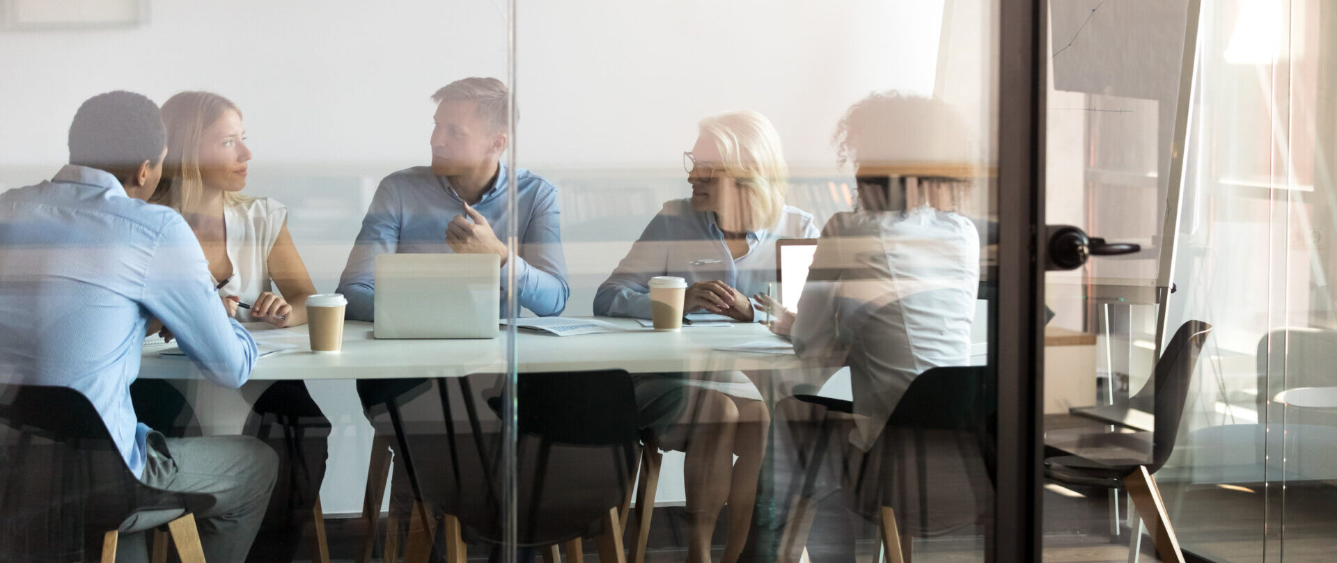 Business people negotiating at boardroom behind closed doors