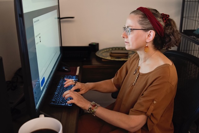 Woman living with a visual disability working at home.