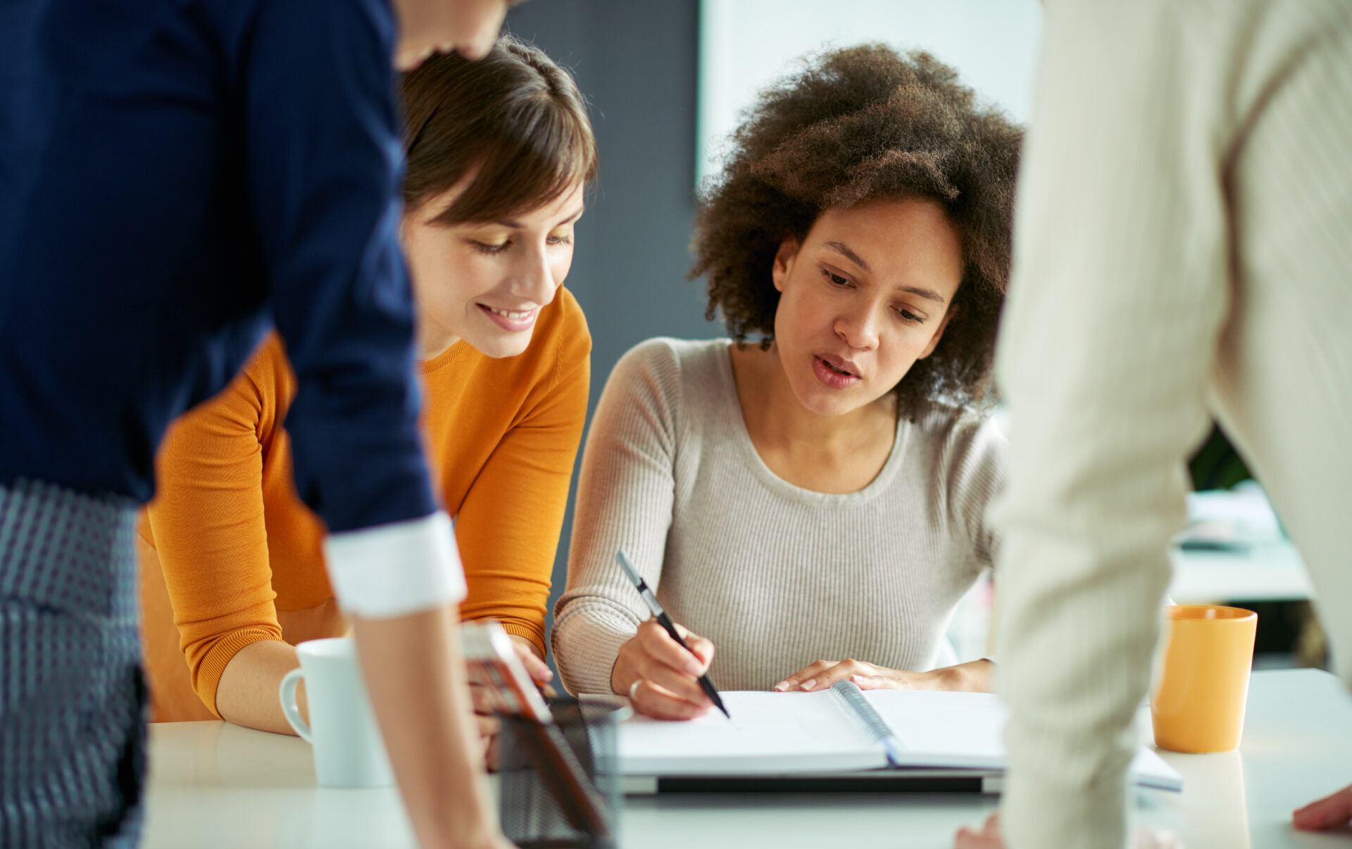 Young people working in modern office, brainstorming together