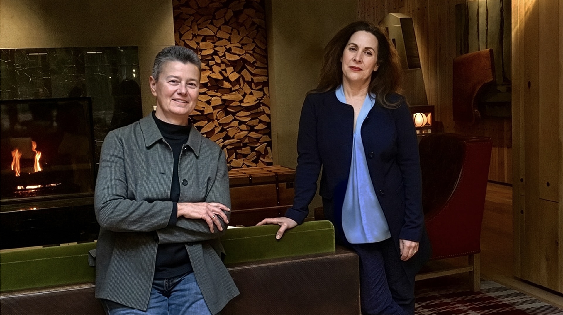 Jody and Cherie in a room with a fireplace
